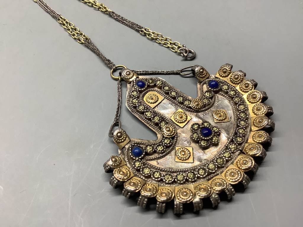 An Afghan? parcel gilt white metal and cabochon lapis lazuli demi-lune shaped pendant necklace